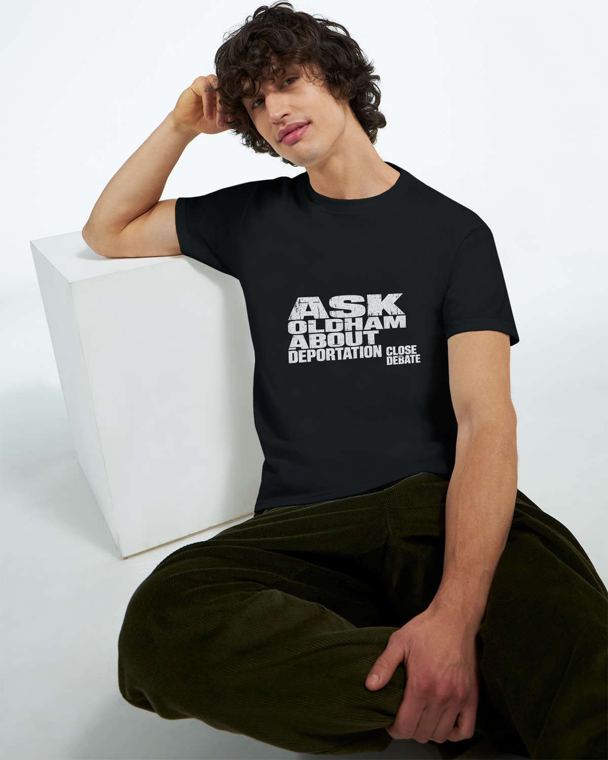 Model wearing the Ask Oldham About Deportation slogan T-shirt in black, front